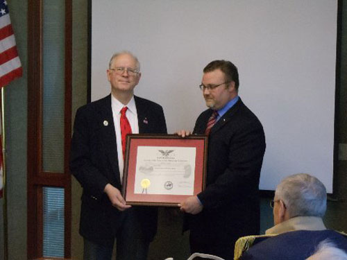 Compatriot Doug Wood, Past President of NHSSAR and VPG NSSAR New England Region, is shown here presenting a Membership Certificate to Compatriot Richard Meister.