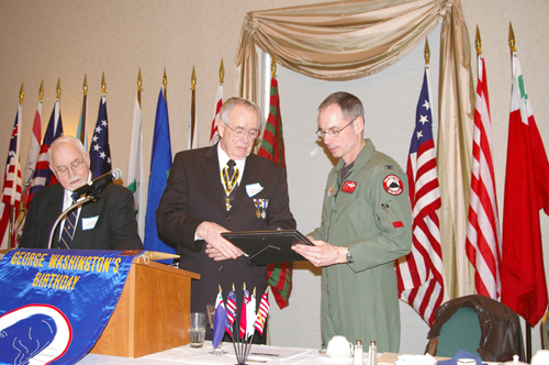 Colonel Greg Champagne, Vice Commander, 131st Fighter Wing, Missouri Air National Guard, St Louis; is shown here receiving a Certificate of Appreciation to be presented to the men and women of our fighting force at Whiteman AFB, MO from Compatriot Romie Carr, Chairman of the George Washington Birthday Celebration Committee. Also shown is Compatriot Ivan Risley, Master of Ceremonies.