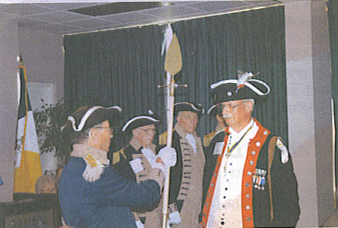 Changing of the Guard - SCD Color Guard Command changed at the 2002 SCD Meeting. Richard F. Arnold, Texas Society Color Guard Commander, turned over the spontoon to Robert L. Grover, Missouri Society Color Guard Commander
